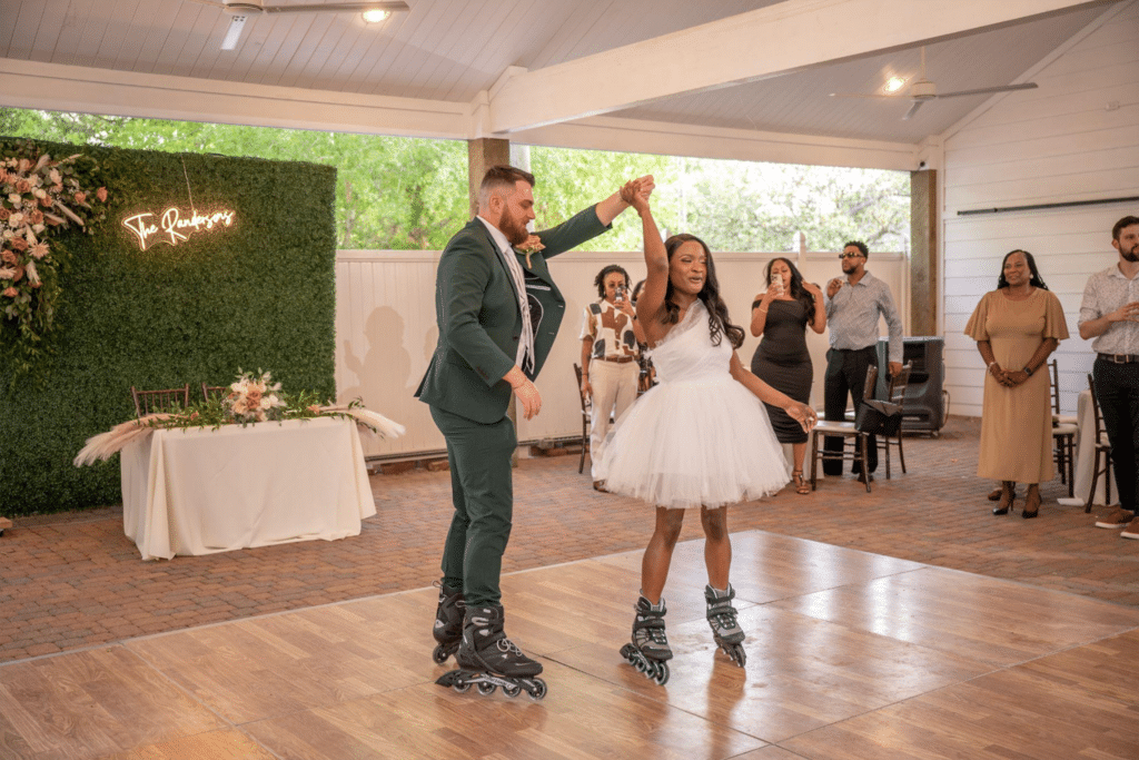 Couple making a fun and unique grand entrance on roller blades into their wedding reception at Butler's Courtyard, Galveston County's premier wedding venue.