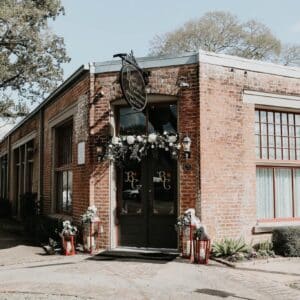 Front door of Butler's Courtyard, a charming historic red brick building with elegant architectural details, perfect for creating a memorable wedding atmosphere for your 2025 celebration.