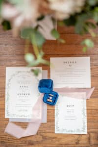 Wedding Invitation with wedding rings laid out beautifully for a flat lay for a couples wedding day detail photos