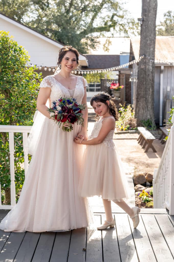 Bride and her daughter pose in their matching dresses moments before the wedding ceremony begins.