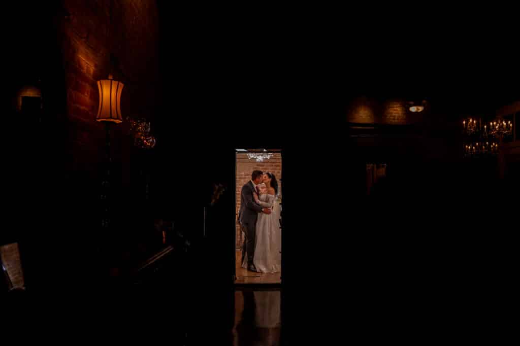 Bride and Groom share a private kiss in the Historic Bank Vault at Butler's Courtyard a Houston wedding venue