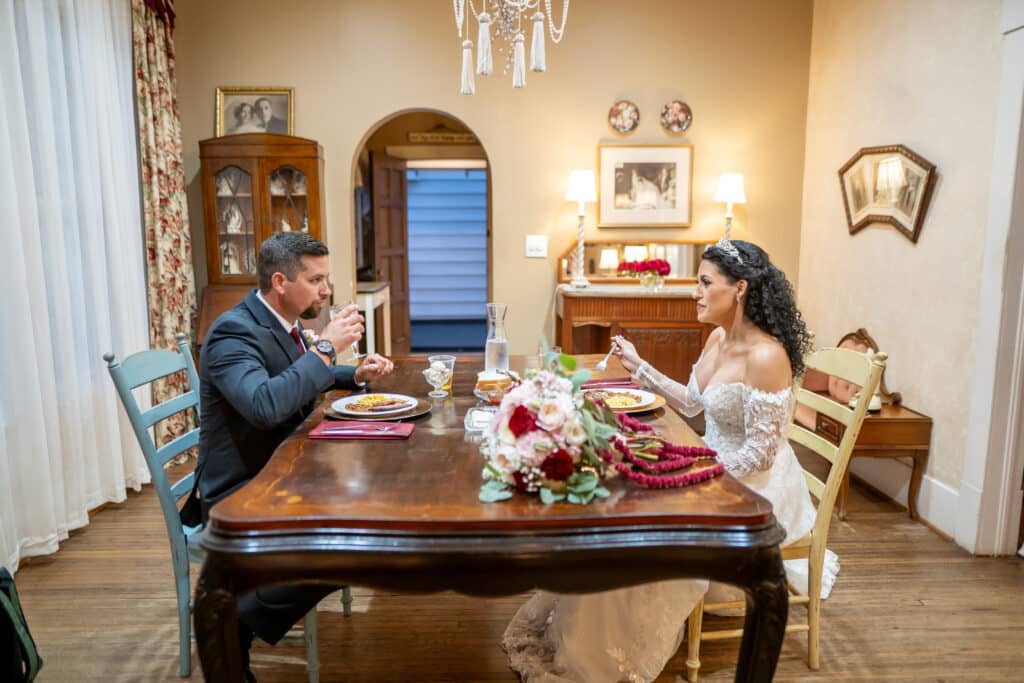 Beautiful Bride and Handsome Groom share an intimate moment after saying "I do" during their private meal at Butler's Courtyard a Galveston County wedding venue