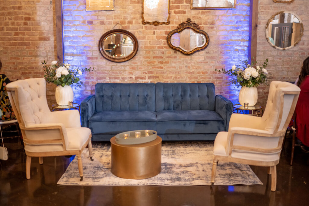 lounge seating at Houston wedding venue showcasing fall décor of white pumpkins and luxurious florals